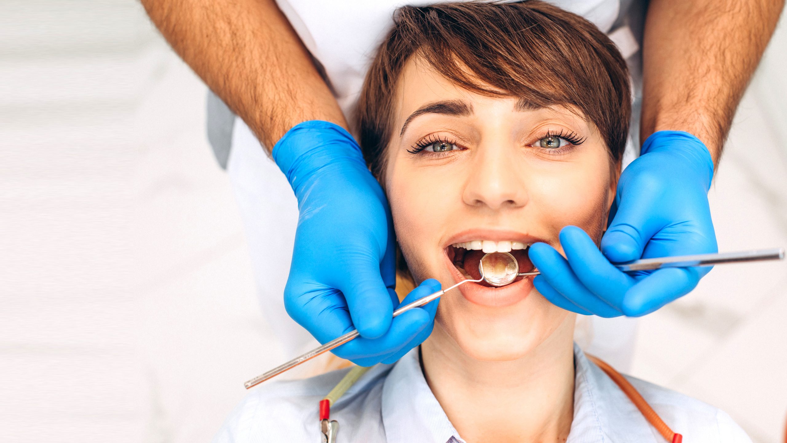 female patient sitting dentist chair making professinal hygiene scaled