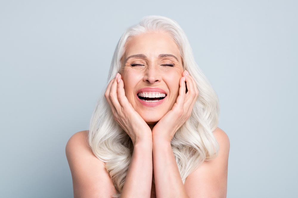 Older women smiling with dental implants