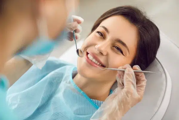 Woman smiling during dental check-up after oral surgery